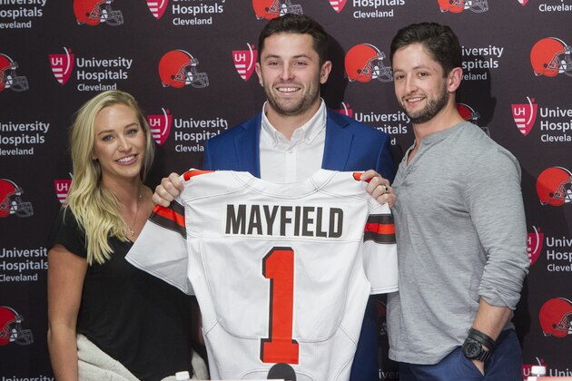 Cleveland Browns first round draft selection, Baker Mayfield, center, stands with is girlfriend, Emily Wilkinson, left and brother Matt Mayfield after a news conference at the Browns headquarters in Berea, Ohio, Friday, April 27, 2018. Mayfield was the first selection of the draft. (AP Photo/Phil Long)