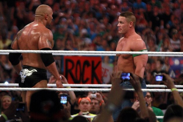 COMMERCIAL IMAGE - In this photograph taken by AP Images for WWE, Dwyane 'The Rock' Johnson, left, and John Cena face off at WrestleMania XXVIII in Sun Life Stadium on Sunday, April 1, 2012 in Miami. (Marc Serota/AP Images for WWE)