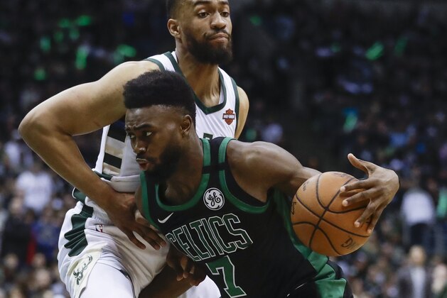 Boston Celtics' Jaylen Brown tries to drive past Milwaukee Bucks' Jabari Parker during the second half of Game 4 of an NBA basketball first-round playoff series Sunday, April 22, 2018, in Milwaukee. The Bucks won 104-102. (AP Photo/Morry Gash)