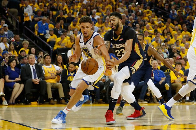 OAKLAND, CA - APRIL 28: Klay Thompson #11 of the Golden State Warriors competes for a loose ball against Anthony Davis #23 of the New Orleans Pelicans during Game One of the Western Conference Semifinals at ORACLE Arena on April 28, 2018 in Oakland, California. NOTE TO USER: User expressly acknowledges and agrees that, by downloading and or using this photograph, User is consenting to the terms and conditions of the Getty Images License Agreement. (Photo by Lachlan Cunningham/Getty Images)