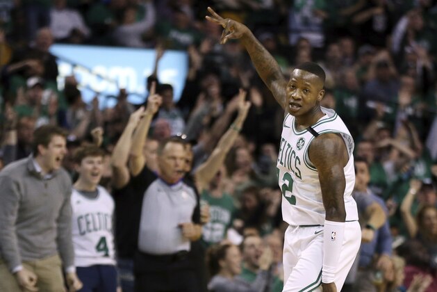 Boston Celtics guard Terry Rozier (12) celebrates his three-point shot against the Philadelphia 76ers in the first quarter of Game 1 of an NBA basketball second-round playoff series, Monday, April 30, 2018, in Boston. (AP Photo/Elise Amendola)