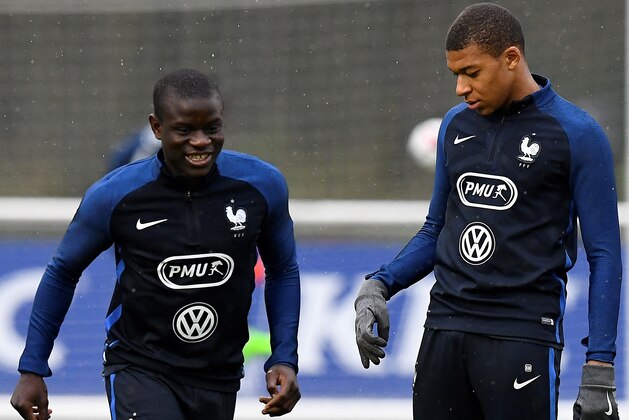 France's midfielder N'Golo Kante (L) runs with a ball next to France's forward Kylian Mbappe Lottin during a training session in Clairefontaine on March 23, 2017, near Paris as part of the team's preparation for the upcoming World Cup 2018 qualifiers. / AFP PHOTO / FRANCK FIFE        (Photo credit should read FRANCK FIFE/AFP/Getty Images)
