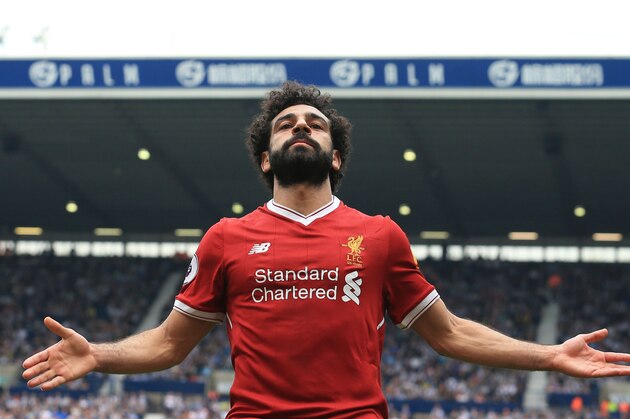 Liverpool's Egyptian midfielder Mohamed Salah celebrates scoring their second goal during the English Premier League football match between West Bromwich Albion and Liverpool at The Hawthorns stadium in West Bromwich, central England, on April 21, 2018. (Photo by Lindsey PARNABY / AFP) / RESTRICTED TO EDITORIAL USE. No use with unauthorized audio, video, data, fixture lists, club/league logos or 'live' services. Online in-match use limited to 75 images, no video emulation. No use in betting, games or single club/league/player publications. /         (Photo credit should read LINDSEY PARNABY/AFP/Getty Images)