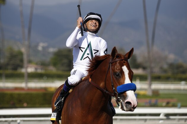 Jockey Mike Smith celebrates after riding Justify to victory in the Santa Anita Derby horse race at Santa Anita Park Saturday, April 7, 2018, in Arcadia, Calif. (AP Photo/Jae C. Hong)