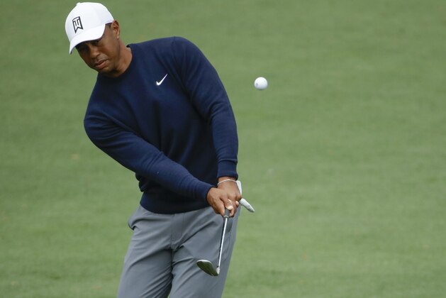 Tiger Woods chips to the second green during a practice round for the Masters golf tournament Wednesday, April 4, 2018, in Augusta, Ga. (AP Photo/Chris Carlson)