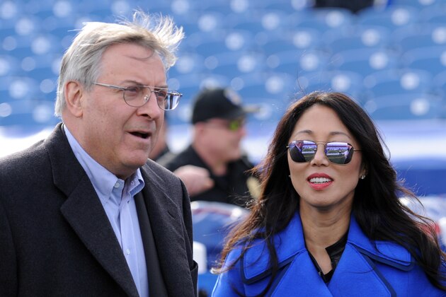 Buffalo Bills owner Terry Pegula, left, and his wife Kim Pegula walk on the field prior to an NFL football game against the Houston Texans, Sunday, Dec. 6, 2015, in Orchard Park, N.Y. (AP Photo/Gary Wiepert)
