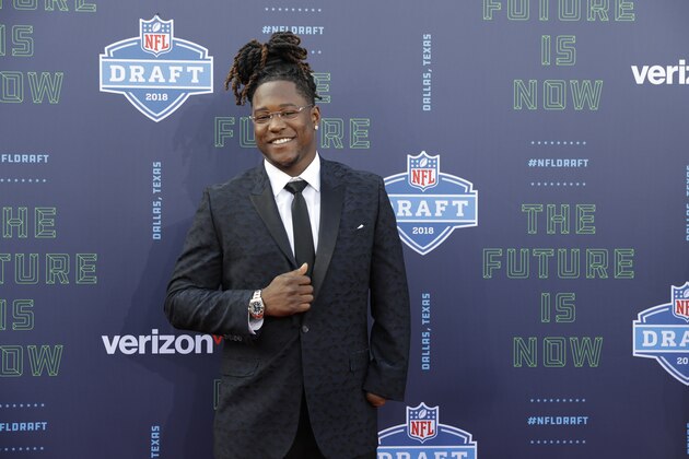 Central Florida's Shaquem Griffin poses for photos on the red carpet before the first round of the NFL football draft, Thursday, April 26, 2018, in Arlington, Texas. (AP Photo/Eric Gay)
