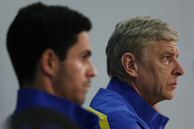 FC Arsenal's French head coach Arsene Wenger (R) and Arsenal's Spanish midfielder Mikel Arteta (L) attend a press conference on the eve of the UEFA Champions League last 16 second leg football match between Bayern Munich and FC Arsenal in Munich, southern Germany, on March 10, 2014. AFP PHOTO / PHILIPP GUELLAND        (Photo credit should read PHILIPP GUELLAND/AFP/Getty Images)