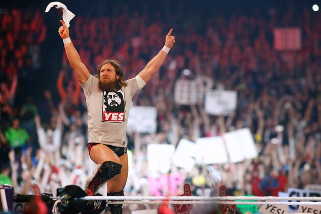 In this April 6, 2014 photo, Daniel Bryan reacts during Wrestlemania XXX at the Mercedes-Benz Super Dome in New Orleans. Bryan was on top of the wrestling world when he won the WWE championship at WrestleMania in 2014. But he is finished just two years later at 35, a victim of at least 10 concussions that ended his career and showed how real-life injuries interrupt fantasy endings.  (Jonathan Bachman/AP Images for WWE)