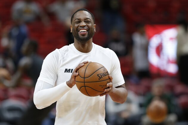 Miami Heat guard Dwyane Wade smiles as he warms up for the team's NBA basketball game against the Milwaukee Bucks, Friday, Feb. 9, 2018, in Miami. Wade was traded back to the Heat from the Cleveland Cavaliers on Thursday. (AP Photo/Wilfredo Lee)