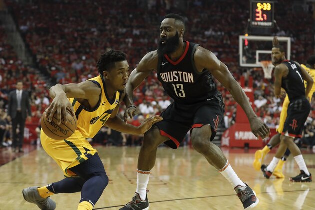 HOUSTON, TX - APRIL 29:  Donovan Mitchell #45 of the Utah Jazz dribbles the ball defended by James Harden #13 of the Houston Rockets in the first half during Game One of the Western Conference Semifinals of the 2018 NBA Playoffs at Toyota Center on April 29, 2018 in Houston, Texas.  NOTE TO USER: User expressly acknowledges and agrees that, by downloading and or using this photograph, User is consenting to the terms and conditions of the Getty Images License Agreement.  (Photo by Tim Warner/Getty Images)