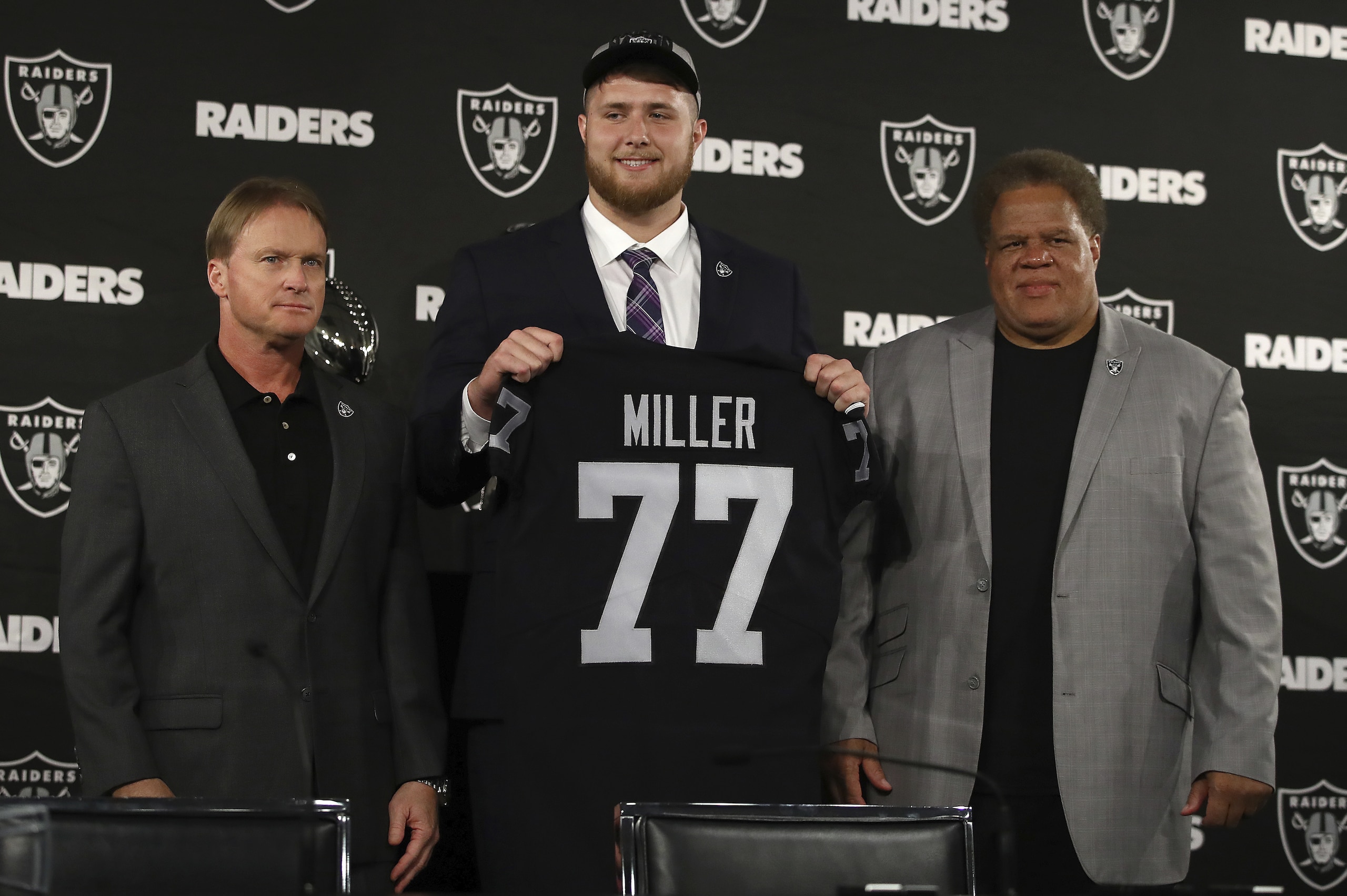 Oakland Raiders draft pick Kolton Miller stands between coach Jon Gruden, left, and General Manager Reggie McKenzie after an NFL football media conference Friday, April 26, 2018, in Alameda, Calif. (AP Photo/Ben Margot) Oakland Raiders draft pick Kolton Miller stands between coach Jon Gruden, left, and General Manager Reggie McKenzie after an NFL football media conference Friday, April 26, 2018, in Alameda, Calif. (AP Photo/Ben Margot)