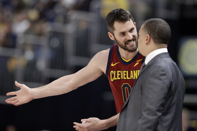 Cleveland Cavaliers' Kevin Love, left, argues with head coach Tyronn Lue on the sideline during the first half of Game 4 of a first-round NBA basketball playoff series against the Indiana Pacers, Sunday, April 22, 2018, in Indianapolis. (AP Photo/Darron Cummings)