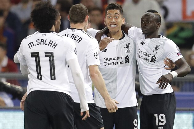 Liverpool's Sadio Mane, right, celebrates scoring his side's first goal with his team during the Champions League semifinal second leg soccer match between Roma and Liverpool at the Olympic Stadium in Rome, Wednesday, May 2, 2018. (AP Photo/Andrew Medichini)