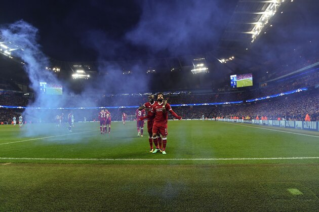 Liverpool's Egyptian midfielder Mohamed Salah celebrates scoring his team's first goal with Liverpool's Senegalese midfielder Sadio Mane during the UEFA Champions League second leg quarter-final football match between Manchester City and Liverpool, at the Etihad Stadium in Manchester, north west England on April 10, 2018. / AFP PHOTO / Paul ELLIS        (Photo credit should read PAUL ELLIS/AFP/Getty Images)