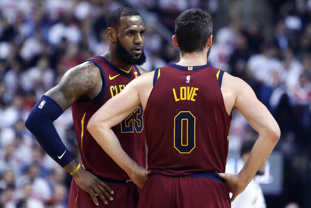 TORONTO, ON - MAY 01:  LeBron James #23 of the Cleveland Cavaliers speaks to Kevin Love #0 in the first half of Game One of the Eastern Conference Semifinals against the Toronto Raptors during the 2018 NBA Playoffs at Air Canada Centre on May 1, 2018 in Toronto, Canada.  NOTE TO USER: User expressly acknowledges and agrees that, by downloading and or using this photograph, User is consenting to the terms and conditions of the Getty Images License Agreement.  (Photo by Vaughn Ridley/Getty Images)