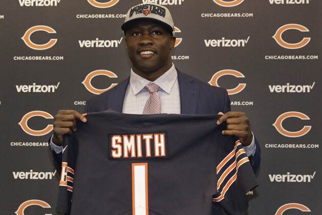 Chicago Bears first round draft pick, University of Georgia linebacker Roquan Smith, poses with a jersey during an introductory NFL football news conference Friday, April 27, 2018, in Lake Forest , Ill. (AP Photo/Charles Rex Arbogast)