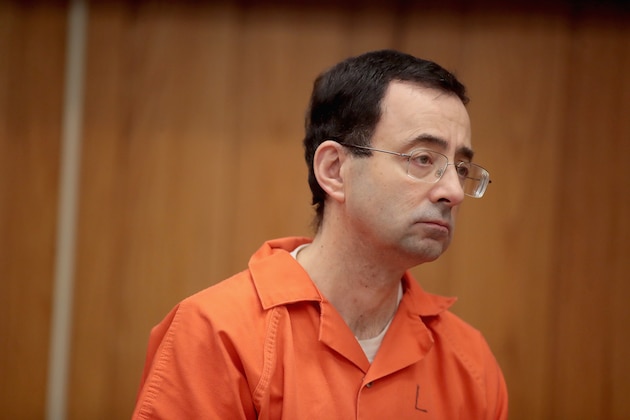 CHARLOTTE, MI - FEBRUARY 05:  Larry Nassar stands as he is sentenced by Judge Janice Cunningham for three counts of criminal sexual assault in Eaton County Circuit Court on February 5, 2018 in Charlotte, Michigan. Nassar has been accused of sexually assaulting more than 150 girls and young women while he was a physician for USA Gymnastics and Michigan State University. Cunningham sentenced Nassar to 40 to 125 years in prison. He is currently serving a 60-year sentence in federal prison for possession of child pornography. Last month a judge in Ingham County, Michigan sentenced Nassar to an 40 to 175 years in prison after he plead guilty to sexually assaulting seven girls.  (Photo by Scott Olson/Getty Images)
