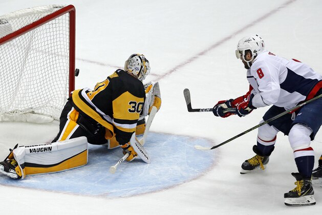 Washington Capitals' Alex Ovechkin (8) puts the game-winning goal behind Pittsburgh Penguins goaltender Matt Murray (30) during the third period in Game 3 of an NHL second-round hockey playoff series in Pittsburgh, Tuesday, May 1, 2018. The Capitals won 4-3. (AP Photo/Gene J. Puskar)