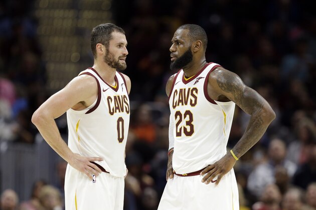 Cleveland Cavaliers' Kevin Love (0) talks with LeBron James (23) in the first half of an NBA basketball game against the Orlando Magic, Saturday, Oct. 21, 2017, in Cleveland. (AP Photo/Tony Dejak)