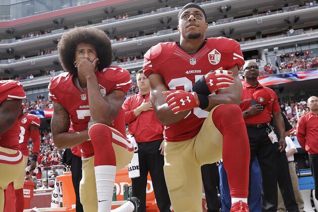 FILE - In this Oct. 2, 2016 file photo, San Francisco quarterback Colin Kaepernick, left, and safety Eric Reid kneel during the national anthem before an NFL football game against the Dallas Cowboys in Santa Clara, Calif. Reid says his Christian faith is the reason why he joined former teammate Colin Kaepernick in kneeling for the anthem. (AP Photo/Marcio Jose Sanchez, File)