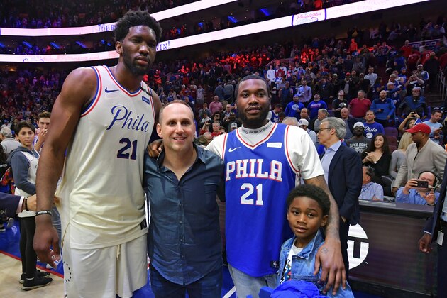 PHILADELPHIA, PA - APRIL 24: (L-R) Joel Embiid #21 of the Philadelphia 76ers, co-owner Michael Rubin, Meek Mill and his son Papi pose for a photograph after the game against the Miami Heat  at Wells Fargo Center on April 24, 2018 in Philadelphia, Pennsylvania. The 76ers won 104-91. (Photo by Drew Hallowell/Getty Images)