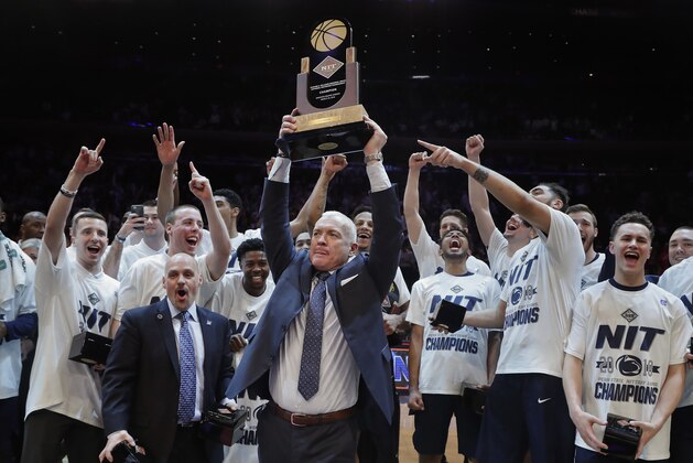 Penn State coach Pat Chambers holds up the NIT championship trophy after Penn State defeated Utah 82-66 in an NCAA college basketball game Thursday, March 29, 2018, in New York. (AP Photo/Julie Jacobson)