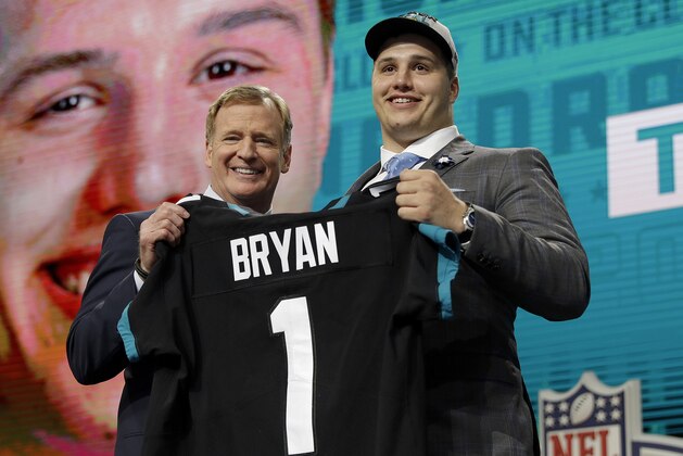 Commissioner Roger Goodell presents Florida's Taven Bryan with his Jacksonville Jaguars team jersey during the first round of the NFL football draft, Thursday, April 26, 2018, in Arlington, Texas. (AP Photo/David J. Phillip)