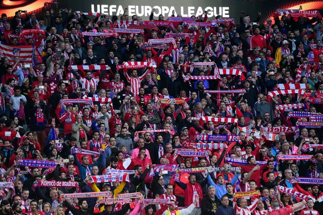 Atletico fans hold up scarves before the UEFA Europa League semi-final second leg football match between Club Atletico de Madrid and Arsenal FC at the Wanda Metropolitano stadium in Madrid on May 3, 2018. (Photo by PIERRE-PHILIPPE MARCOU / AFP)        (Photo credit should read PIERRE-PHILIPPE MARCOU/AFP/Getty Images)