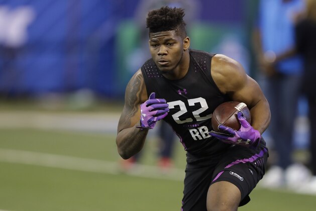San Diego State running back Rashaad Penny runs a drill during the NFL football scouting combine, Friday, March 2, 2018, in Indianapolis. (AP Photo/Darron Cummings)