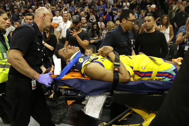Golden State Warriors guard Patrick McCaw is taken off the court on a stretcher after falling hard to the floor late in the third quarter following a Flagrant 1 foul by Sacramento Kings's Vince Carter in an NBA basketball game Saturday, March 31, 2018, in Sacramento, Calif. The Warriors won 112-96. (AP Photo/Rich Pedroncelli)