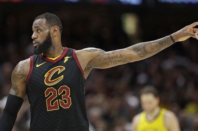 Cleveland Cavaliers' LeBron James talks with a teammate in the second half of Game 7 of an NBA basketball first-round playoff series against the Indiana Pacers, Sunday, April 29, 2018, in Cleveland. (AP Photo/Tony Dejak)