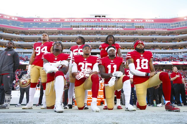 SANTA CLARA, CA - DECEMBER 17: Eli Harold #57, Eric Reid #35, Marquise Goodwin #11 and Louis Murphy #18 of the San Francisco 49ers kneel on the sideline during the anthem as Solomon Thomas #94, Reuben Foster #56 and Adrian Colbert #38 stand with them in support, prior to the game against the Tennessee Titans at Levi's Stadium on December 17, 2017 in Santa Clara, California. The 49ers defeated the Titans 25-23. (Photo by Michael Zagaris/San Francisco 49ers/Getty Images)