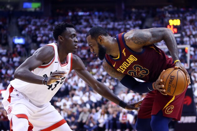 TORONTO, ON - MAY 03:  LeBron James #23 of the Cleveland Cavaliers dribbles the ball as Pascal Siakam #43 of the Toronto Raptors defends in the second half of Game Two of the Eastern Conference Semifinals during the 2018 NBA Playoffs at Air Canada Centre on May 3, 2018 in Toronto, Canada.  NOTE TO USER: User expressly acknowledges and agrees that, by downloading and or using this photograph, User is consenting to the terms and conditions of the Getty Images License Agreement.  (Photo by Vaughn Ridley/Getty Images)