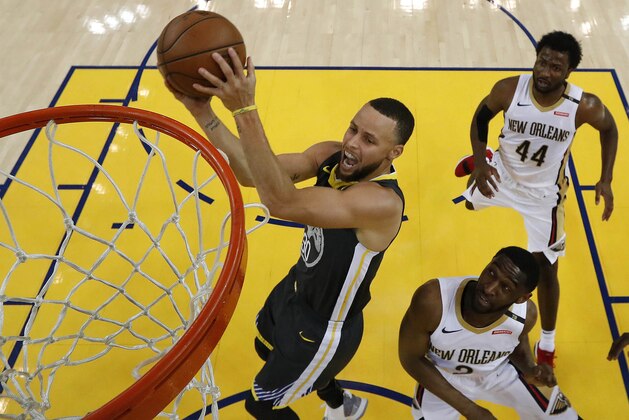 Golden State Warriors' Stephen Curry lays up a shot over New Orleans Pelicans' Ian Clark, right, and Solomon Hill (44) during Game 2 of a second-round NBA basketball playoff series, Tuesday, May 1, 2018, in Oakland, Calif. Golden State won 121-116. (John G. Mabanglo/Pool Photo via AP)