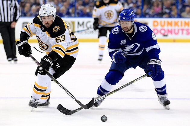 TAMPA, FL - APRIL 28:  Brad Marchand #63 of the Boston Bruins and Tyler Johnson #9 of the Tampa Bay Lightning fight for the puck during Game One of the Eastern Conference Second Round  during the 2018 NHL Stanley Cup Playoffs at Amalie Arena on April 28, 2018 in Tampa, Florida.  (Photo by Mike Ehrmann/Getty Images)