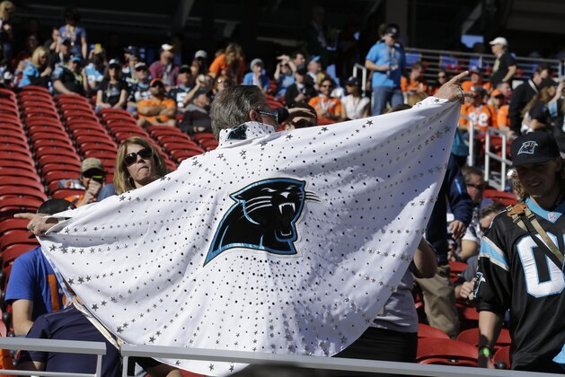 A Carolina Panthers fan displays a cape with the team's logo before the NFL Super Bowl 50 football game between the Denver Broncos and the Carolina Panthers, Sunday, Feb. 7, 2016, in Santa Clara, Calif. (AP Photo/Ben Margot)