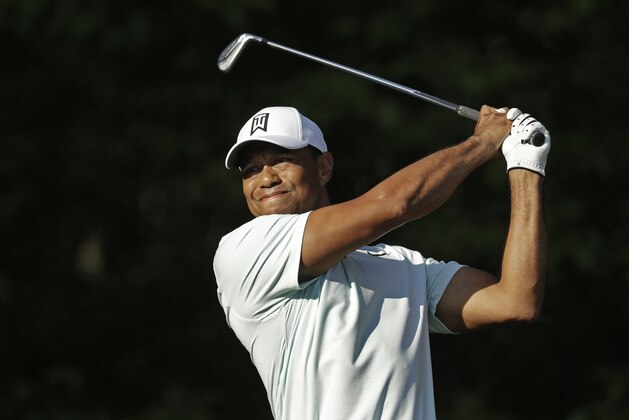 Tiger Woods watches his shot on the 12th hole during the second round of the Wells Fargo Championship golf tournament at Quail Hollow Club in Charlotte, N.C., Friday, May 4, 2018. (AP Photo/Chuck Burton)