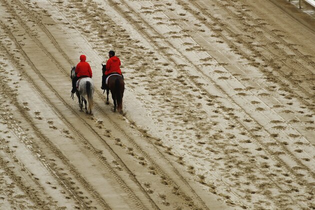 Outriders walk on the track before the 144th running of the Kentucky Derby horse race at Churchill Downs Saturday, May 5, 2018, in Louisville, Ky. (AP Photo/Charlie Riedel)