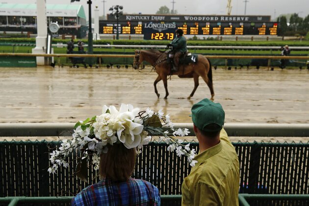 Fans watch as a horse walks on the track before the 144th running of the Kentucky Derby horse race at Churchill Downs Saturday, May 5, 2018, in Louisville, Ky. (AP Photo/Charlie Riedel)