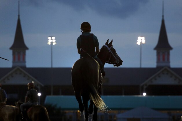 A horse heads onto the track for a morning workout at Churchill Downs Friday, May 4, 2018, in Louisville, Ky. The 144th running of the Kentucky Derby is scheduled for Saturday. (AP Photo/Charlie Riedel)