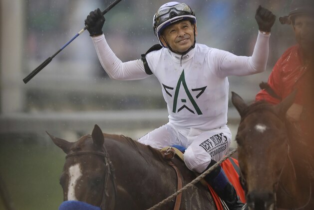 Mike Smith celebrates after riding Justify to victory during the 144th running of the Kentucky Derby horse race at Churchill Downs Saturday, May 5, 2018, in Louisville, Ky. (AP Photo/Darron Cummings)
