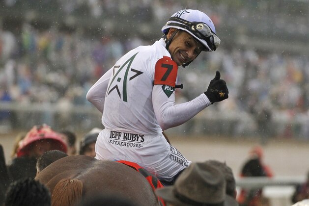 Mike Smith celebrates after riding Justify to victory during the 144th running of the Kentucky Derby horse race at Churchill Downs Saturday, May 5, 2018, in Louisville, Ky. (AP Photo/Garry Jones)