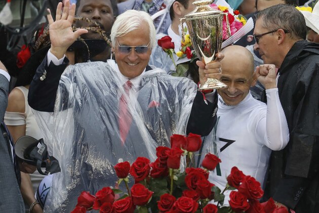 Mike Smith celebrates after riding Justify to victory with trainer Bob Baffert, left, during the 144th running of the Kentucky Derby horse race at Churchill Downs Saturday, May 5, 2018, in Louisville, Ky. (AP Photo/John Minchillo)