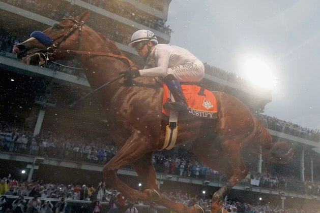 LOUISVILLE, KY - MAY 05:  Justify #7, ridden by jockey Mike Smith crosses the finish line to win the 144th running of the Kentucky Derby at Churchill Downs on May 5, 2018 in Louisville, Kentucky.  (Photo by Rob Carr/Getty Images)