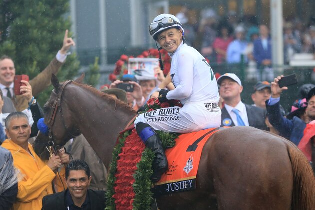 LOUISVILLE, KY - MAY 05:  Jockey Mike Smith poses for a photo in the winner's circle atop of Justify #7 after winning the 144th running of the Kentucky Derby at Churchill Downs on May 5, 2018 in Louisville, Kentucky.  (Photo by Sean M. Haffey/Getty Images)