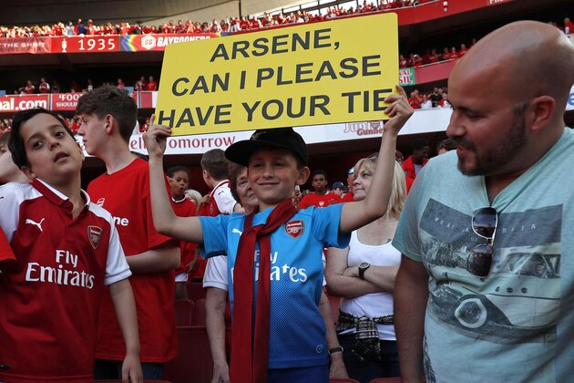 A young supporter, seven year old Luca Iacurti wears a tie which Arsenal's French manager Arsene Wenger was wearing after the English Premier League football match between Arsenal and Burnley at the Emirates Stadium in London on May 6, 2018. - Arsene Wenger bids farewell to a stadium he helped to build in more ways than one when he leads Arsenal at the Emirates for the final time at home to Burnley on Sunday. Wenger's final season after 22 years in charge is destined to end in disappointment after Thursday's Europa League semi-final exit. (Photo by Adrian DENNIS / AFP) / RESTRICTED TO EDITORIAL USE. No use with unauthorized audio, video, data, fixture lists, club/league logos or 'live' services. Online in-match use limited to 75 images, no video emulation. No use in betting, games or single club/league/player publications. /         (Photo credit should read ADRIAN DENNIS/AFP/Getty Images)