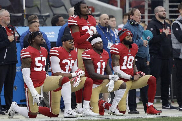 San Francisco 49ers outside linebacker Eli Harold, from bottom left, kneels with safety Eric Reid, wide receiver Marquise Goodwin and wide receiver Louis Murphy during the national anthem before an NFL football game against the Jacksonville Jaguars in Santa Clara, Calif., Sunday, Dec. 24, 2017. (AP Photo/Marcio Jose Sanchez)