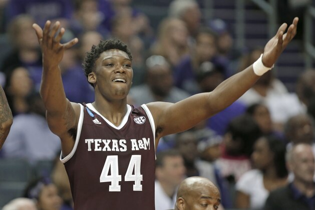 Texas A&M's Robert Williams (44) celebrates on the bench during the second half of a second-round game against North Carolina in the NCAA men's college basketball tournament in Charlotte, N.C., Sunday, March 18, 2018. (AP Photo/Bob Leverone)
