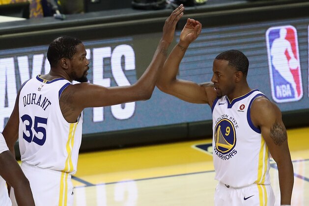 OAKLAND, CA - APRIL 24:  Kevin Durant #35 high fives Andre Iguodala #9 of the Golden State Warriors during their game against the San Antonio Spurs during Game Five of Round One of the 2018 NBA Playoffs at ORACLE Arena on April 24, 2018 in Oakland, California.  NOTE TO USER: User expressly acknowledges and agrees that, by downloading and or using this photograph, User is consenting to the terms and conditions of the Getty Images License Agreement.  (Photo by Ezra Shaw/Getty Images)